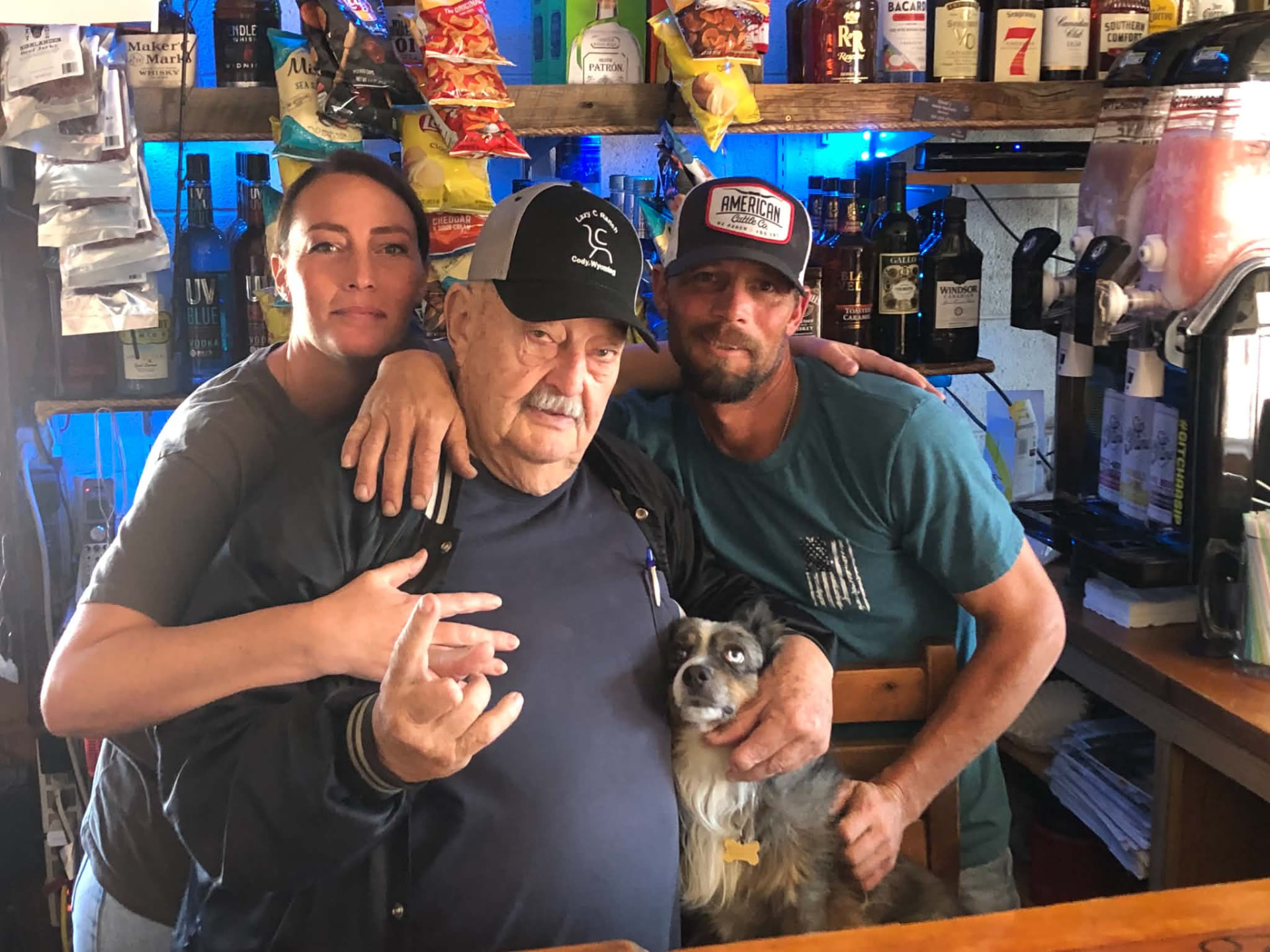 Jim behind the bar with his family and his loyal dog, Buckwheat

